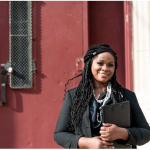 picture of Principal in front of school door